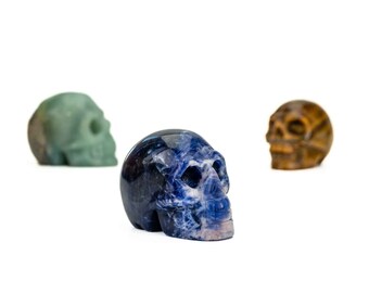 Crystal skull carvings, Amethyst, Clear Quartz, Tigers Eye, Sodalite, Rhodonite, Caribbean calcite 5cmx 4 cm