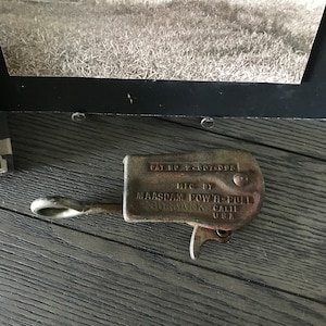 May include: A rusty metal Maasdam Power-Pull cable puller with the text "Pat. No. 2,607,095. Lic. by Maasdam Power-Pull Burbank, Calif. U.S.A."