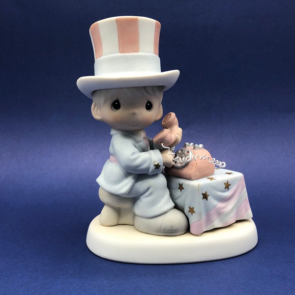 Precious Moments Vintage 1999 Figurine "Let Freedom Ring" features a little Uncle Sam in Striped Top Hat using a Rotary Phone.  5" tall