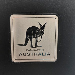 May include: A silver sticker with a black silhouette of a kangaroo and the text "Kangaroo Australia".