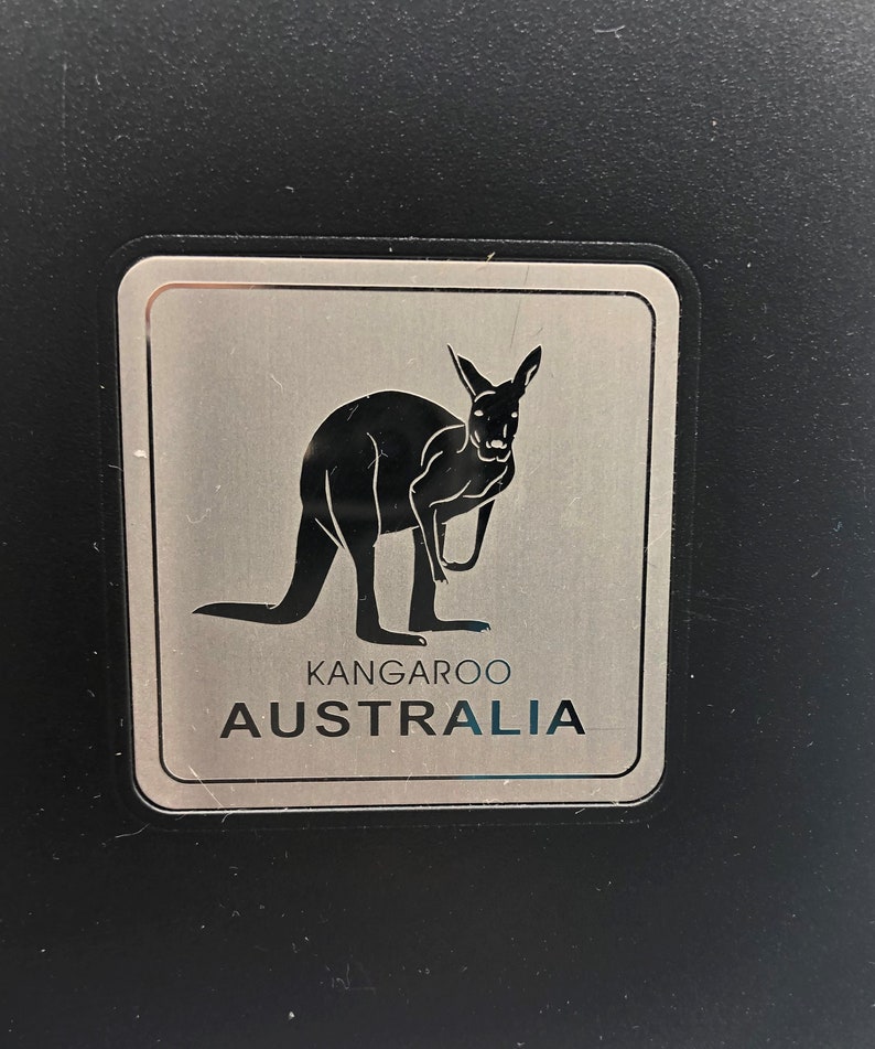 May include: A silver sticker with a black silhouette of a kangaroo and the text "Kangaroo Australia".