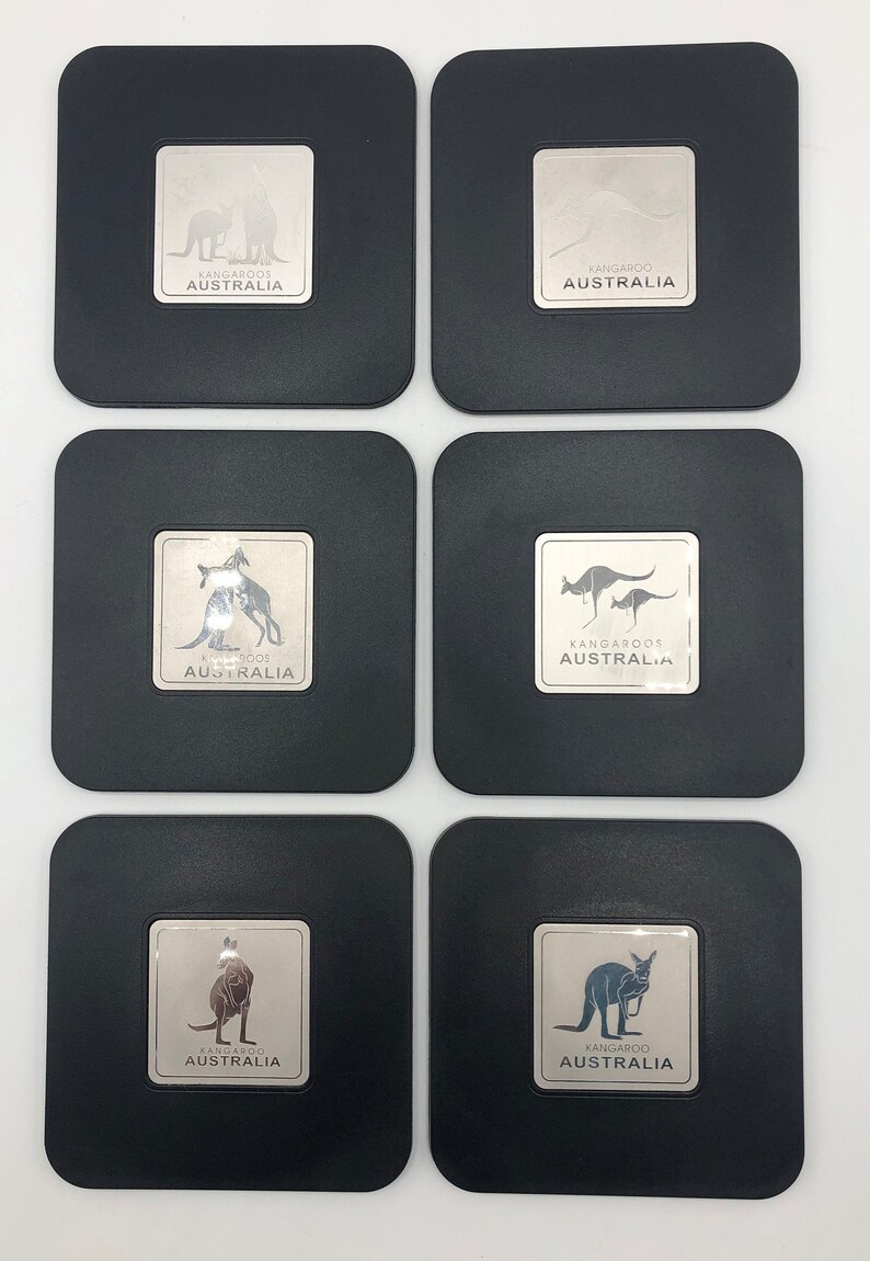 May include: Six black square coasters with silver metallic insets featuring a kangaroo silhouette and the text "Kangaroos Australia".