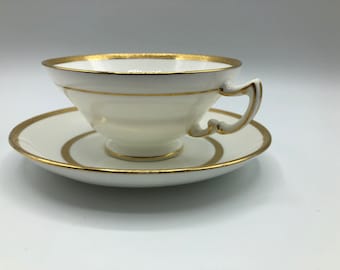 Vintage Mintons of England Footed Tea Cup and Saucer with Brilliant Gold Detail and Trim by Sim & Co. Troy NY.  Elegant and beautiful.