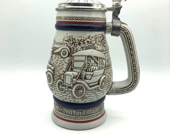 Avon Antique Cars 1979 Handcrafted Stein made in Brazil. Highly detailed sculpted cars. 6" wide with handle 8.75" high with lid 2 lbs. 7 oz.