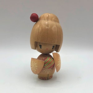 Japanese Kokeshi Wooden Doll. Hand crafted from turned wood and hand painted. 2.5&quot; wide x 4.5&quot; tall