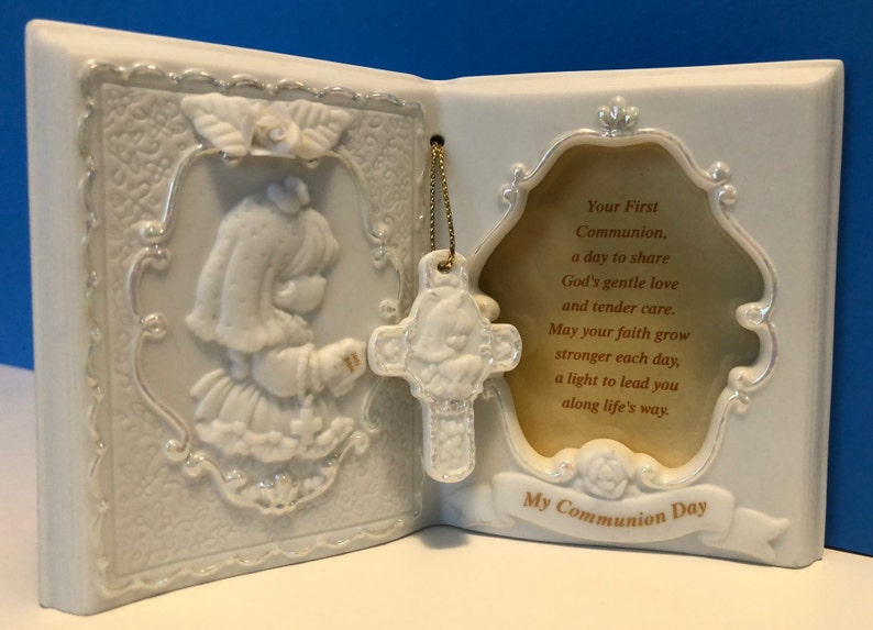 Precious Moments First Communion Keepsake Beautifully detailed image of a girl holding a Bible ready to receive her First Holy Communion.