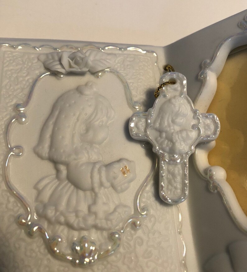 Precious Moments First Communion Keepsake Beautifully detailed image of a girl holding a Bible ready to receive her First Holy Communion.