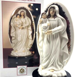 Musical Madonna and Child. White Porcelain Figurine Hand Painted with Brilliant Gold Accents, Wooden Base. Plays O Holy Night. 5&quot; x 10&quot; high