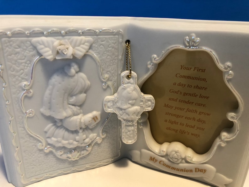 Precious Moments First Communion Keepsake Beautifully detailed image of a girl holding a Bible ready to receive her First Holy Communion.