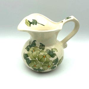 Vintage Pottery Pitcher Made & Hand Painted by the Cash Family with beautiful green flowers and leaves. Excellent Condition. 4.5&quot; x 6&quot; x 5&quot;