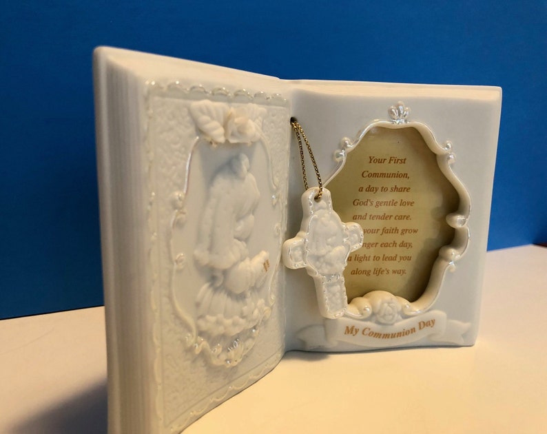 Precious Moments First Communion Keepsake Beautifully detailed image of a girl holding a Bible ready to receive her First Holy Communion.
