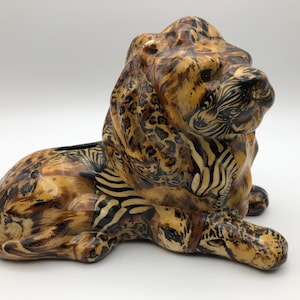 Unique and Beautiful Ceramic Lion bank with finish that has details of multiple jungle animals.  4&quot; x 8&quot; x 6&quot; high  Excellent Condition