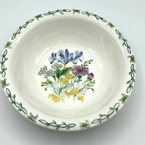 Thomson Pottery China 7" bowl in "Floral Garden" pattern with blue iris, purple zinnia flowers with green vines and leaves around the rim.