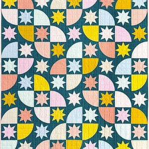 May include: A colourful quilt with a geometric pattern. The design features quarter-circle shapes in yellow, pink, and white, interspersed with star-shaped accents. The background is a deep teal colour, and the quilt is likely made of cotton.