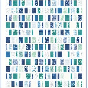 May include: A quilt with a white background and a pattern of rectangular blocks in shades of blue, teal, and white. The blocks are arranged in vertical and horizontal rows, creating a grid-like design. The quilt is bordered with a dark blue frame.
