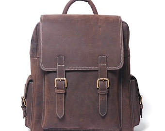 May include: A brown leather backpack with two adjustable buckles and side pockets. The backpack has a top handle and a distressed leather look.