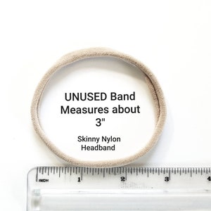 May include: A beige nylon headband measuring approximately 3 inches in diameter. The headband is unused and is shown next to a ruler.
