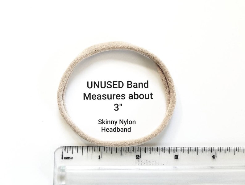 May include: A beige nylon headband measuring approximately 3 inches in diameter. The headband is unused and is shown next to a ruler.