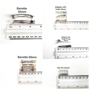 May include: Four different types of hair clips with measurements in inches. The clips are silver metal and include a barrette measuring 2.36 inches, a barrette measuring 1.97 inches, an alligator clip with teeth measuring 1.77 inches, and a single prong alligator clip measuring 1.77 inches.