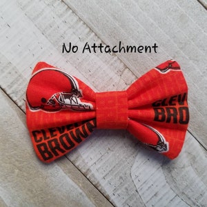 May include: Orange bow tie with a brown and white Cleveland Browns logo and the words "Cleveland Browns".