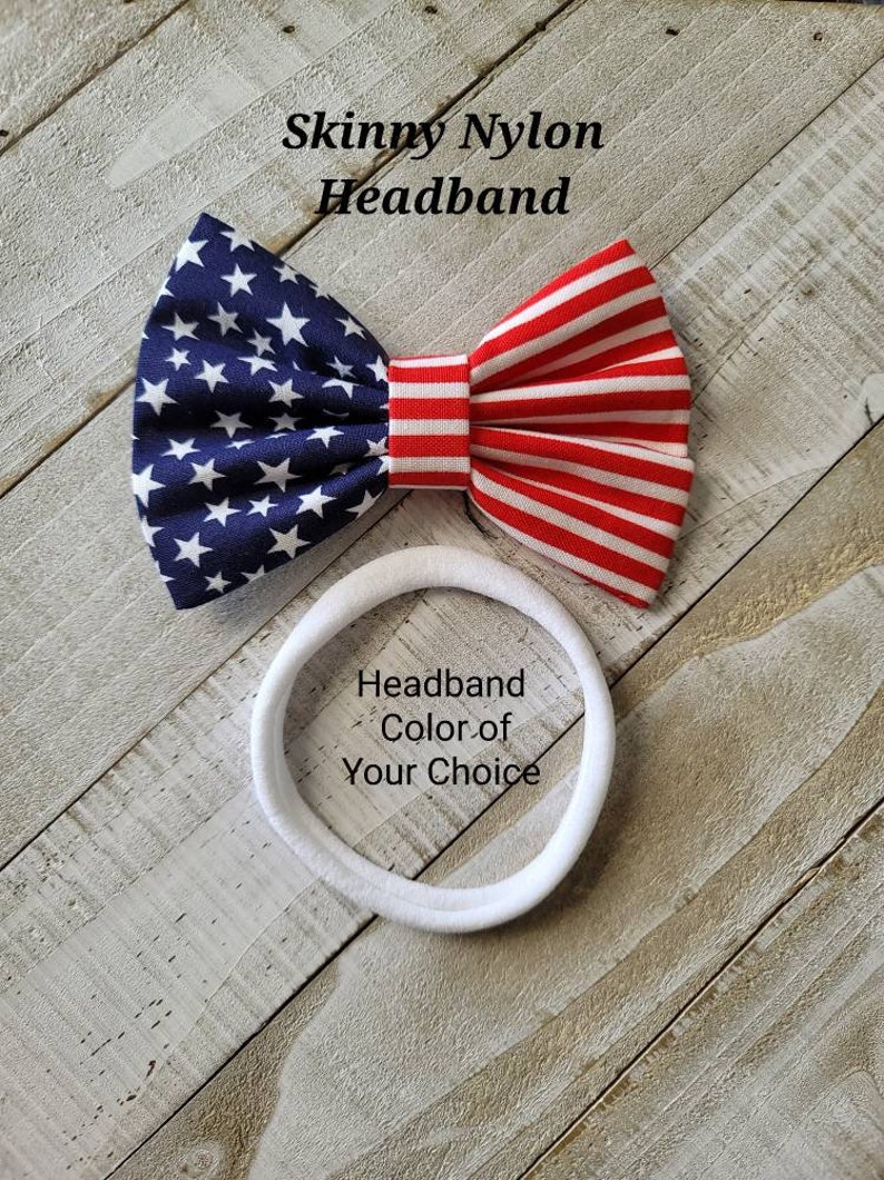 May include: A red, white, and blue American flag bow headband. The headband is made of nylon and is available in a variety of colors. "Headband Color of Your Choice" is written on the headband.