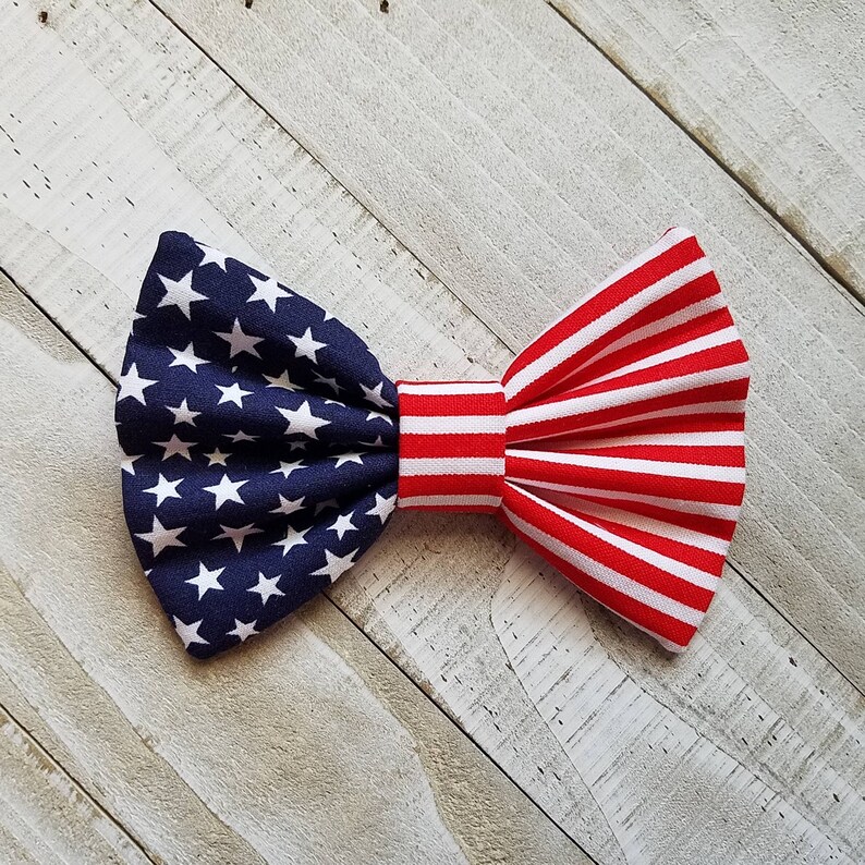 May include: A red, white, and blue bow tie with a star pattern on one side and stripes on the other. The bow tie is made of fabric and is suitable for a variety of occasions.