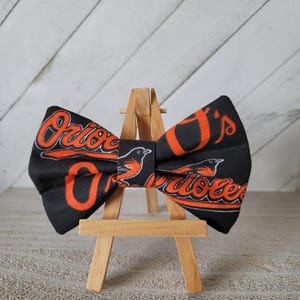 Baltimore Baseball Bow Tie | Men&#39;s Bow Tie | Teens Bow Tie | Pet Bow Tie | Black Neck Strap with Clasp |  Pet Velcro Loop, Approx. 5&quot;L × 3&quot;H