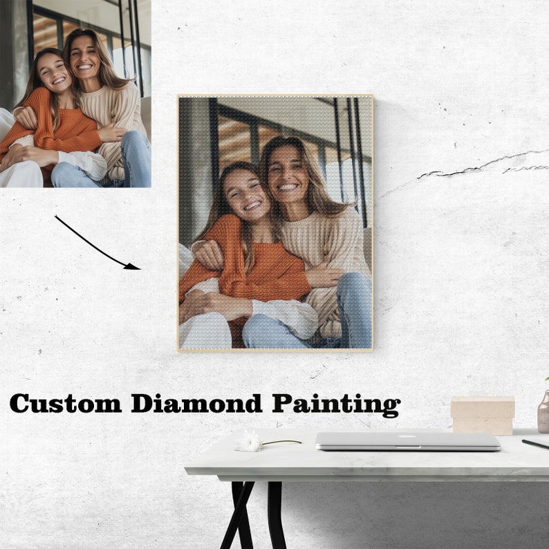 May include: A custom diamond painting of two women smiling and hugging. The women are wearing casual clothing and are sitting in a room with a window in the background. The painting is framed and ready to hang.