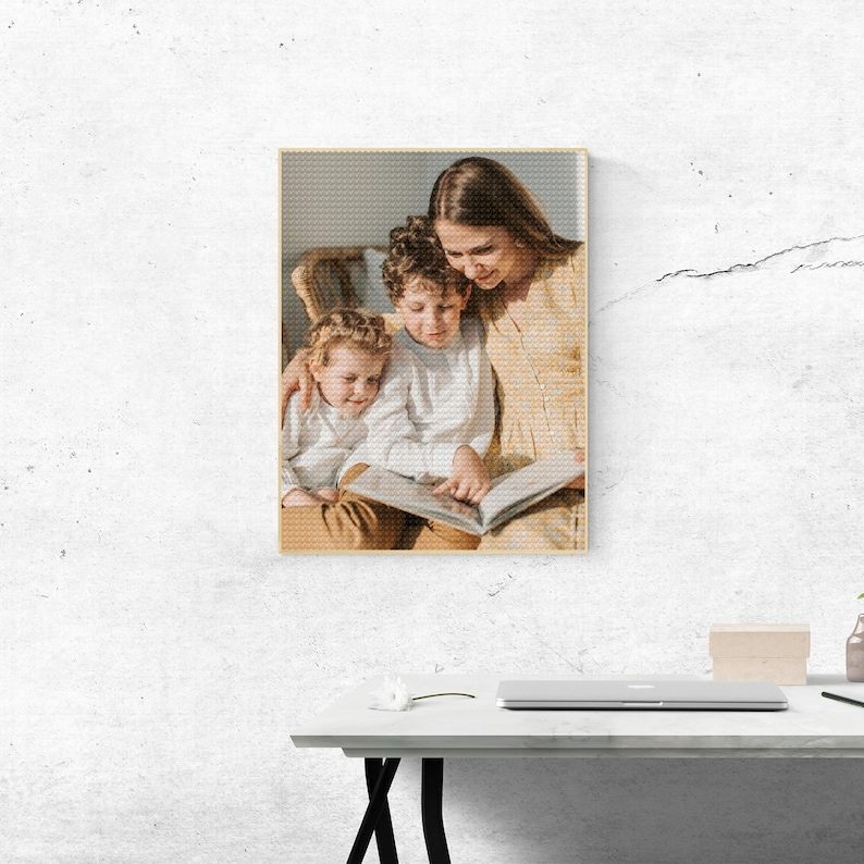 May include: A woman and two children sitting on a chair, reading a book together. The woman is wearing a light yellow dress and the children are wearing light blue shirts. The woman is smiling and the children are looking at the book.