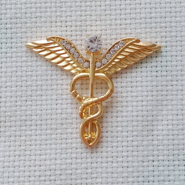 Caduceus Needle Minder - Medium Golden Metal Medic Emblem With Clear Rhinestones and is Magnetic