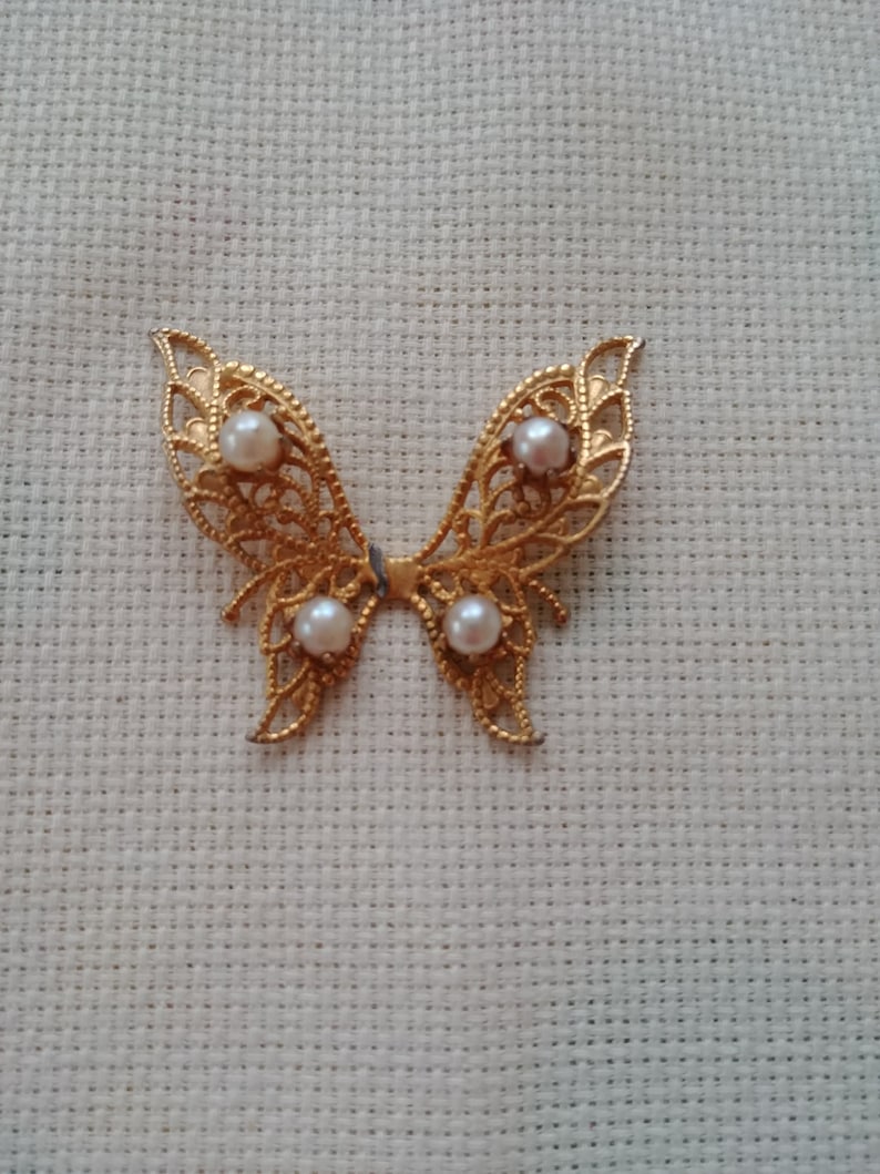 Needle Minder Medium Golden Metal Butterfly with Faux Pearls On The Wings and is Magnetic