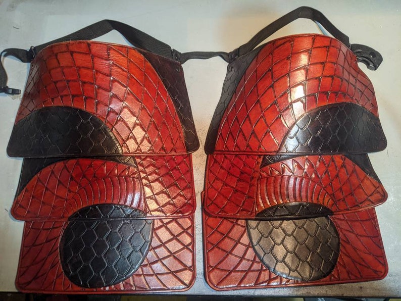 May include: Four leather panels with a red and black dragon scale pattern. The panels are stacked on top of each other.