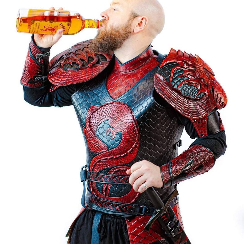 May include: A person wearing red and black leather armour with a dragon design. The armour is detailed with scales and has a belt with a sword attached. The person is holding a bottle of alcohol and drinking from it.