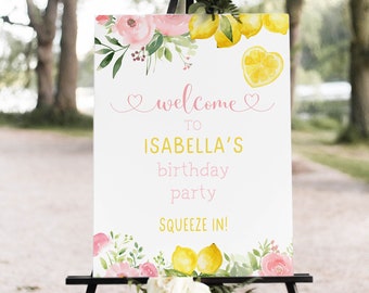 May include: Welcome to Isabella's birthday party, a lemon-themed party with a watercolor floral design. The sign says "Squeeze In!"