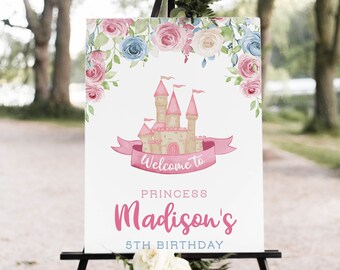 May include: A sign on a black easel with a princess theme. The sign features a pink castle, floral accents, and the text "Welcome to Princess Madison's 5th Birthday."