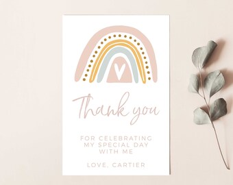 May include: A thank you card with a rainbow design in pink, yellow, and blue with gold dots. The text on the card reads "Thank you for celebrating my special day with me. Love, Cartier."