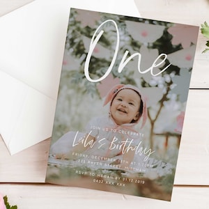 May include: A birthday invitation featuring a photo of a baby girl wearing a pink bunny hat. The invitation reads "One" and "Leila's Birthday" with the date and time of the party. RSVP details are provided.