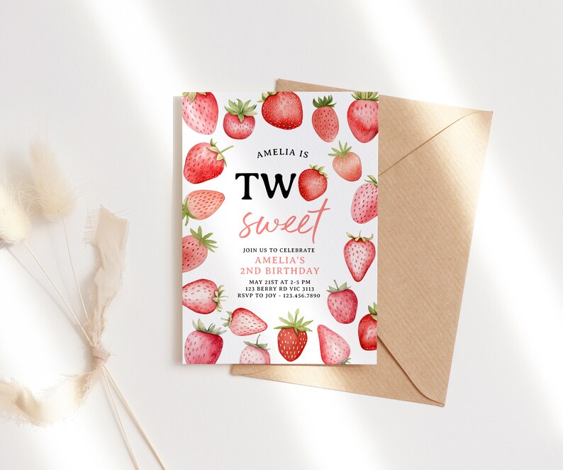 a card with strawberries on it next to a flower