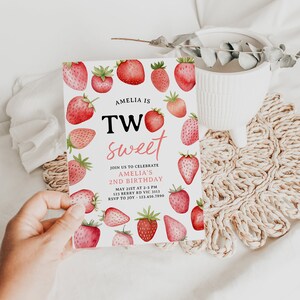 a person holding up a strawberry sweet birthday card