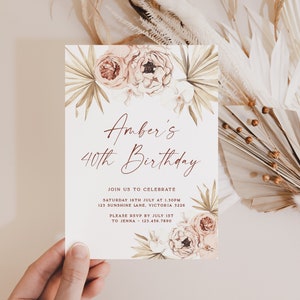 a person holding up a card with flowers on it