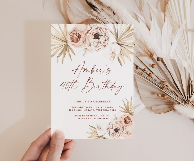 a person holding up a card with flowers on it
