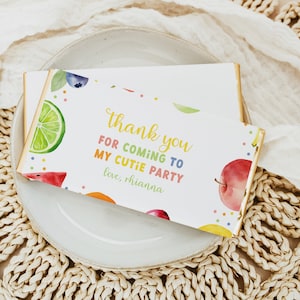 May include: A colourful thank you card with a fruit theme. The card says "Thank you for coming to my cutie party, love, Rhianna".