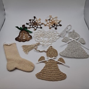 May include: A collection of handmade crochet Christmas ornaments. Includes a beige stocking, brown bell with green ribbon, snowflakes, angels, and a doily. The ornaments are in shades of brown, beige, and white, perfect for holiday decorating.