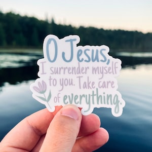May include: A sticker with a floral design and the text "O Jesus, I surrender myself to you. Take care of everything."