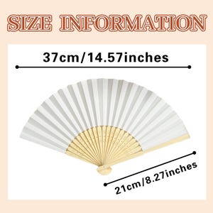 May include: A white paper hand fan with a light wood handle, open to display its pleated design. The fan is 14.57 inches wide and 8.27 inches tall. The text "SIZE INFORMATION" is at the top.