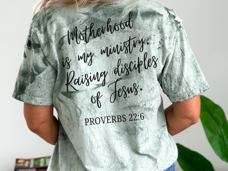May include: A green tie-dye t-shirt with the text "Motherhood is my ministry. Raising disciples of Jesus. Proverbs 22:6" printed on the back.
