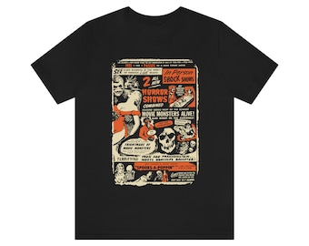 May include: A black t-shirt with a vintage-style poster design featuring a horror movie double feature. The poster is orange and black and features a variety of monsters, including a werewolf, a vampire, and a Frankenstein's monster. The text on the poster reads "2 All New Horror Shows Combined!" and "Movie Monsters Alive!"