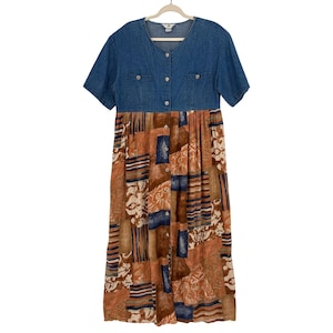 May include: A midi-length dress featuring a blue denim bodice with short sleeves, a round neckline, and two chest pockets. The skirt is a patchwork design in shades of brown, tan, and blue with a button-down front closure extending from the bodice.