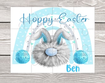 May include: A blue and white rainbow puzzle with a fluffy gray bunny rabbit in the center. The bunny has blue ears and a blue nose. The puzzle has the words "Hoppy Easter" and the name "Ben" on it.
