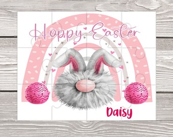 May include: A pink and white Easter puzzle featuring a fluffy bunny with pink ears and a pink nose. The bunny is surrounded by a pink and white rainbow with the words "Hoppy Easter" and the name "Daisy".